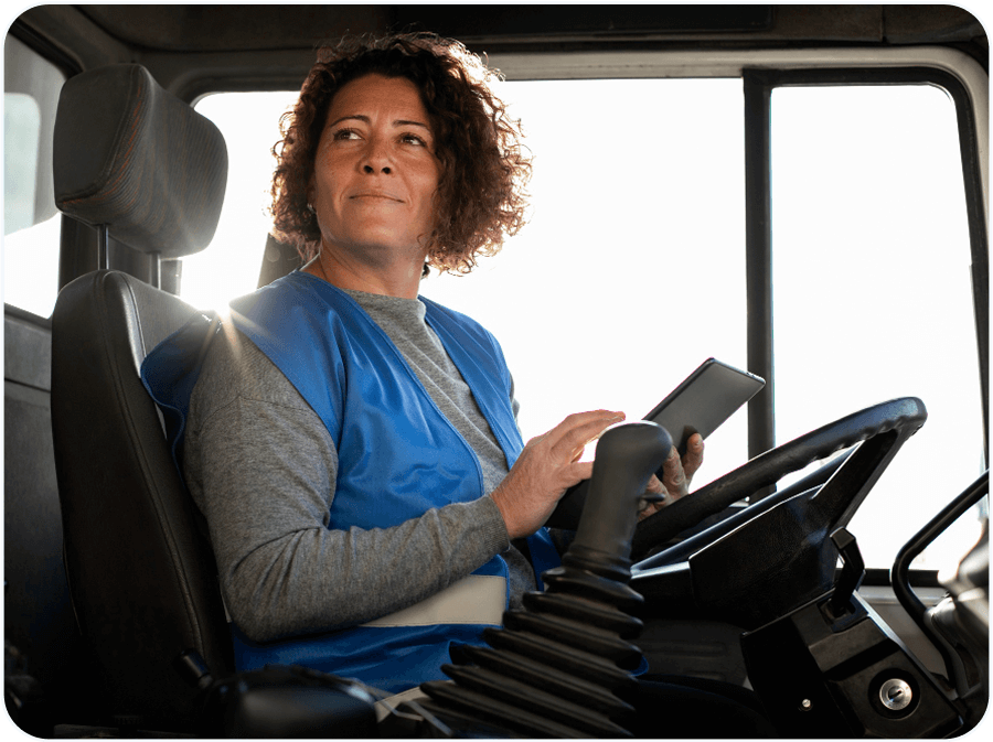 Professional female van sales representative using tablet in delivery vehicle for automated invoicing and electronic proof of delivery with RouteMagic software